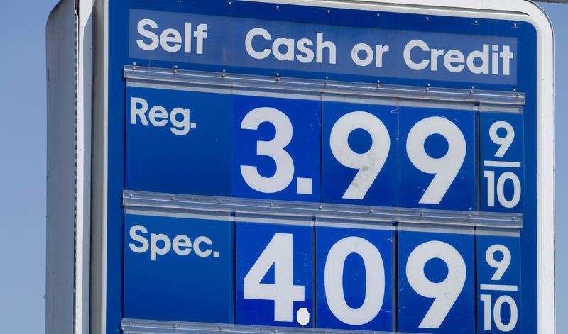a sign shows high gas prices
