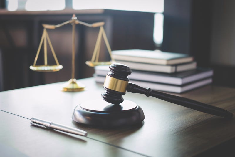 Scales of justice and gavel on wooden table