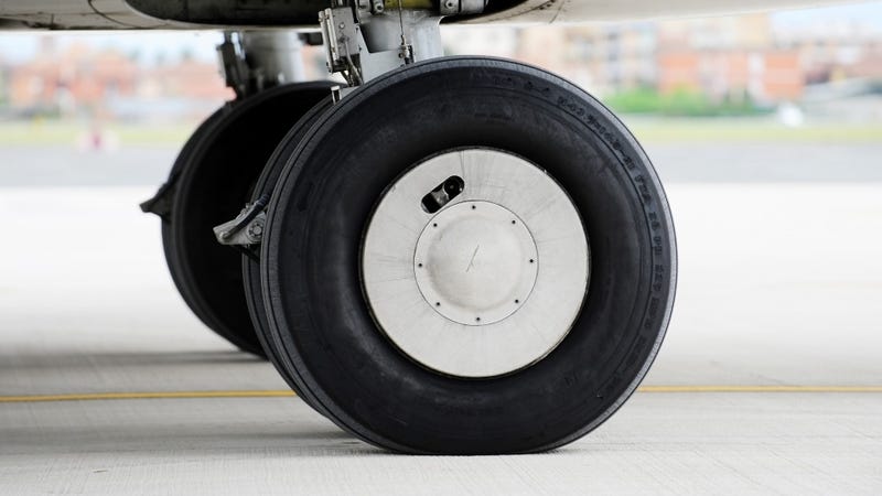 Detail shot with big airplane wheels and landing gear