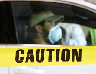 At a pilot large scale drive-through COVID-19 testing site in the Georgia International Horse Park on Thursday, April 16, 2020, in Conyers, Ga. (Curtis Compton/Atlanta Journal-Constitution via AP)