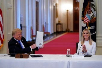FILE - In this June 26, 2020, file photo, Ivanka Trump, right, applauds as President Donald Trump holds an executive order that he signed during a meeting with the American Workforce Policy Advisory Board. (AP Photo/Evan Vucci, File)