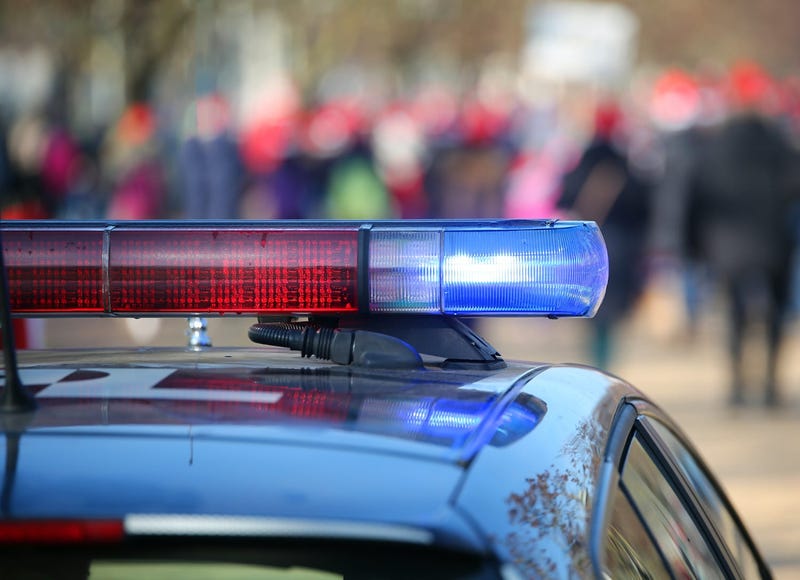 Police cars with sirens lit during the uprising through the streets of the city