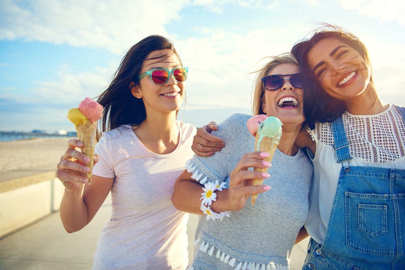 Laughing teenage girls eating ice cream cones