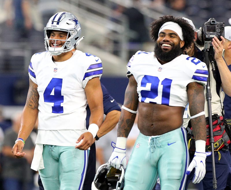  Dak Prescott #4 of the Dallas Cowboys and Ezekiel Elliott #21 of the Dallas Cowboys smile during warm ups before the preseason game against the Arizona Cardinals at AT&T Stadium.