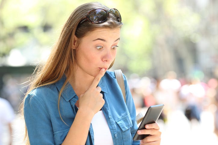 Embarrassed woman on the phone