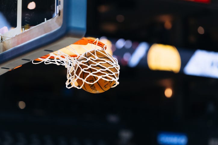 A basketball player makes a basket