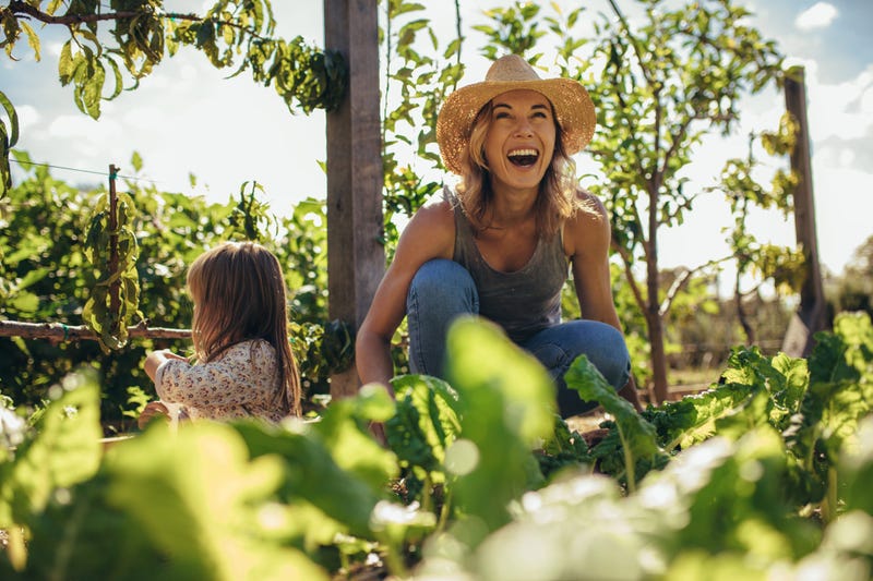 Woman and girl gardening