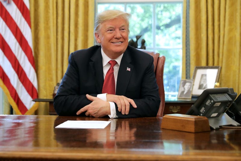 U.S. President Donald Trump talks to reporters while hosting workers and members of his cabinet for a meeting in the Oval Office at the White House October 17, 2018 in Washington, DC.