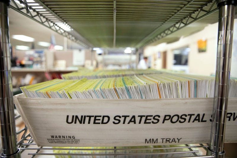 Mailed in ballots sit in US Postal Service bins inside the office of the Stanislaus County Clerk on November 6, 2018 in Modesto, California.