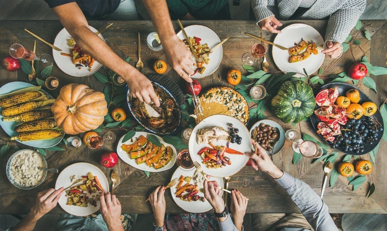 People eating a holiday table.