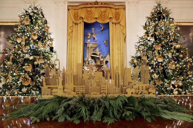 Four 14-foot-tall Nobel fir trees with 72 handmade paper ornaments representing six regions across America stand next to the White House Crèche in the East Room of the White House Nov. 26, 2018 in Washington, D.C.