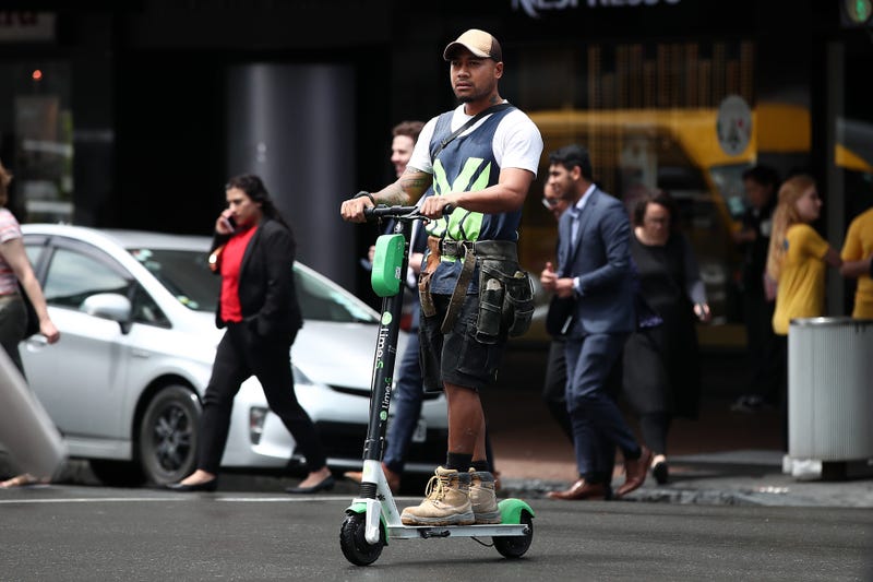 Guy riding a Lime scooter