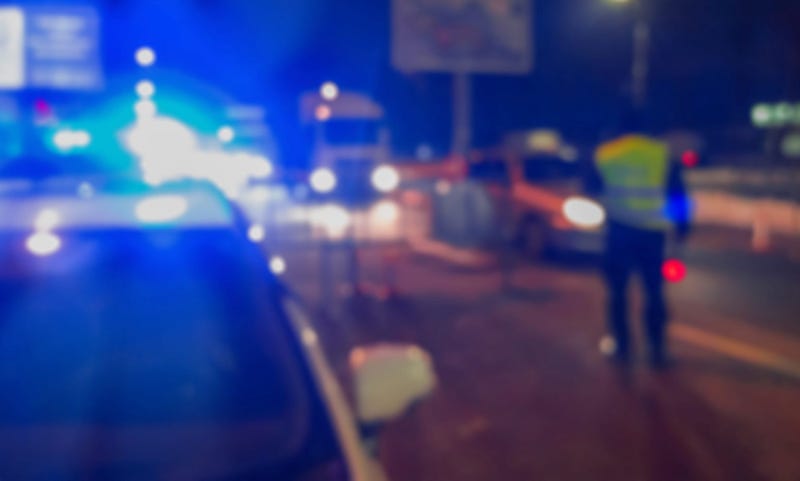 Police investigate the scene of a traffic accident at night