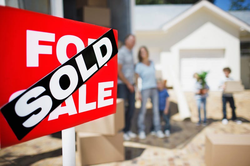 House sold with happy family in the background