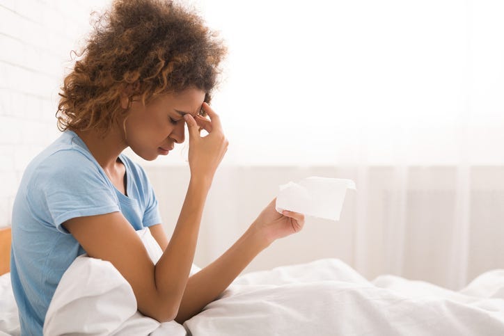 A woman sick in bed.