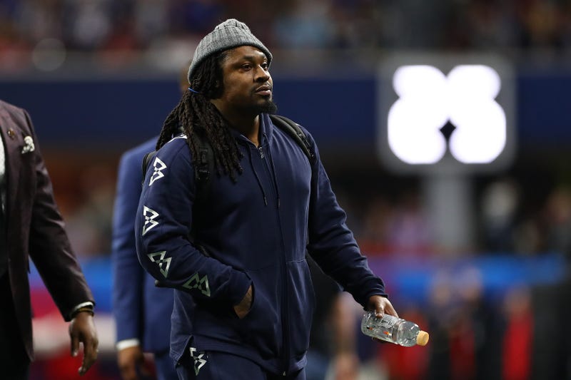 Marshawn Lynch rides around Oakland, handing out masks