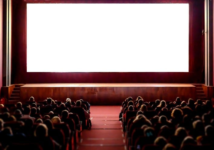 People watching a movie in a theatre.