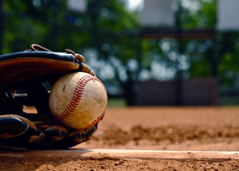 Baseball in glove on team field