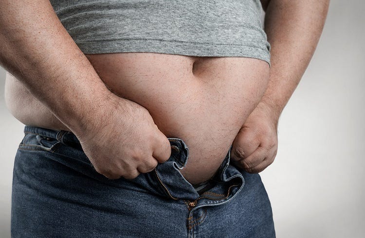 Overweight man trying to wear too small jeans