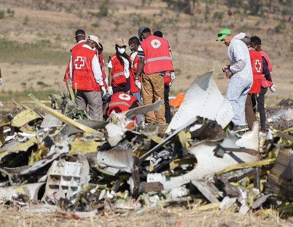 Forensics investigators and recovery teams collect personal effects and other materials from the crash site of Ethiopian Airlines Flight ET 302 on March 12, 2019 in Bishoftu, Ethiopia.