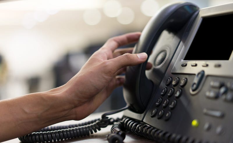 A person picking up a phone 