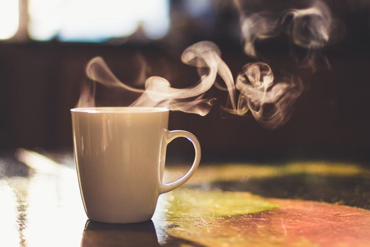 A cup of a hot drink.