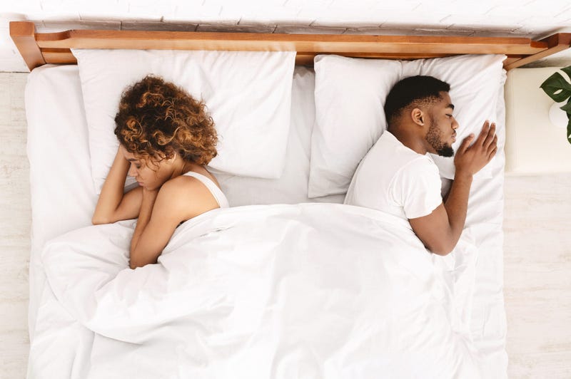 unhappy couple in bed
