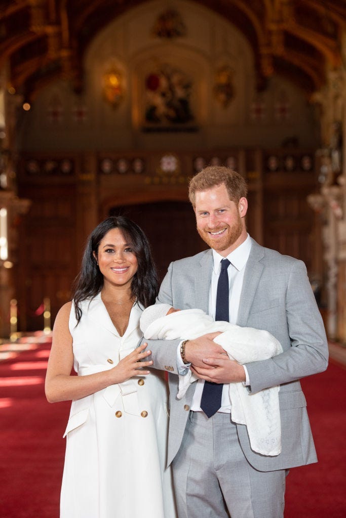 Prince Harry, Duke of Sussex and Meghan, Duchess of Sussex, pose with their newborn son during a photocall in St George's Hall at Windsor Castle on May 8, 2019 in Windsor, England.