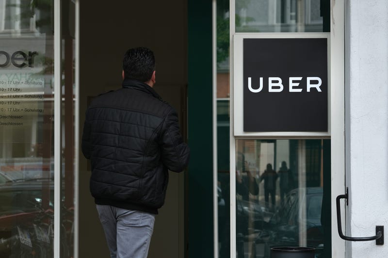 A man enters an Uber drivers registration office.