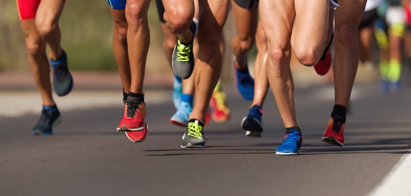 Marathon running race, people feet on city road