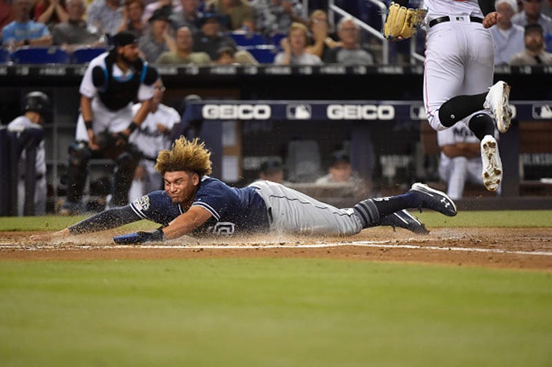 Josh Naylor #22 of the San Diego Padres slides across home plate during the second inning against the Miami Marlins at Marlins Park on July 16, 2019 in Miami, Florida. (Photo by Eric Espada/Getty Images)