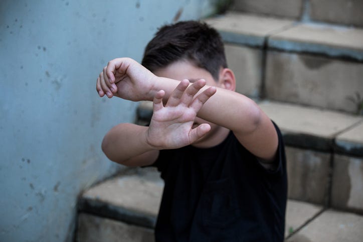 A little boy protects himself with his palms and covers his face. Stop abusing boy violence. violence, terrified , A fearful child 