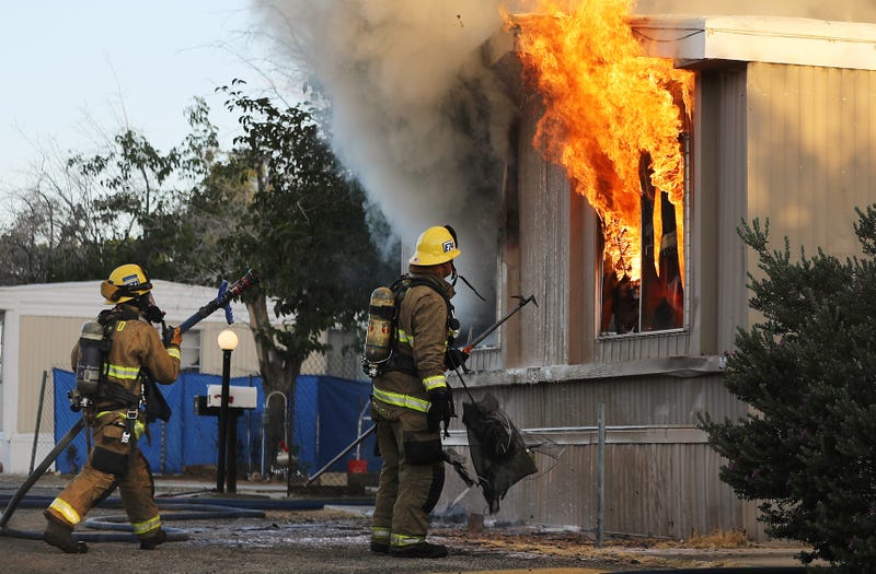 Firefighters work to put out an electrical house fire, the morning after a 7.1 magnitude earthquake struck in the area, on July 6, 2019 in Ridgecrest, California.
