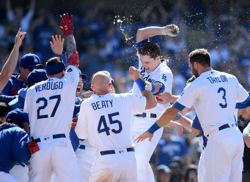 Will Smith #16 of the Los Angeles Dodgers jumps at home plate in celebration of his walk-off two run homerun, for a 5-3 win over the Colorado Rockies, during the ninth inning at Dodger Stadium on June 23, 2019