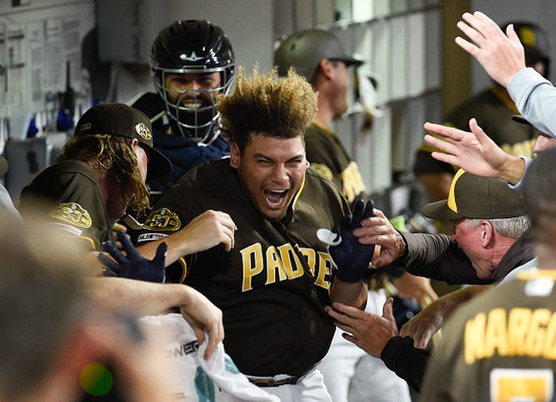 Josh Naylor #22 of the San Diego Padres is congratulated in the dugout after hitting a three-run home run during the eighth inning of a baseball game against the Colorado Rockies at Petco Park August 9, 2019 in San Diego, California. (Photo by Denis Poroy