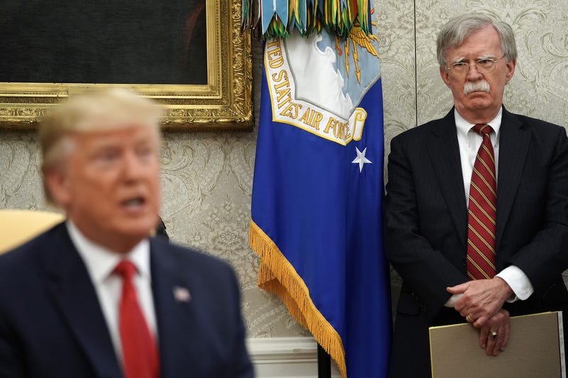 WASHINGTON, DC - JULY 18: White House National Security Advisor John Bolton (R) listens to U.S. President Donald Trump as he and Dutch Prime Minister Mark Rutte talk to reporters in the Oval Office at the White House July 18, 2019 in Washington, DC. Accor