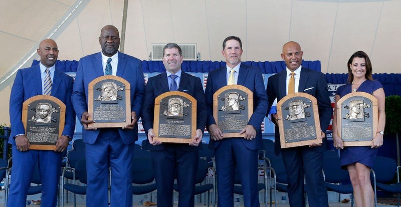 : Inductees (from left) Harold Baines, Lee Smith, Edgar Martinez, Mike Mussina, Mariano Rivera and Brandy Halladay, wife the late Roy Halladay, pose with their plaques 