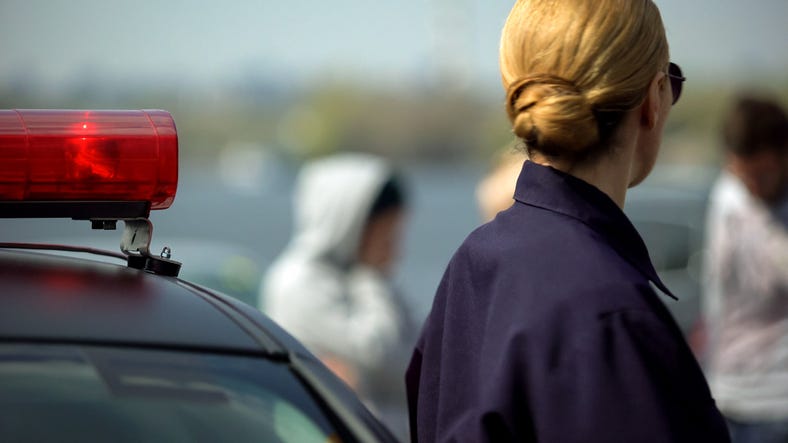olice woman arrived on police automobile to crime scene, car accident, crash PREMIUM ACCESS