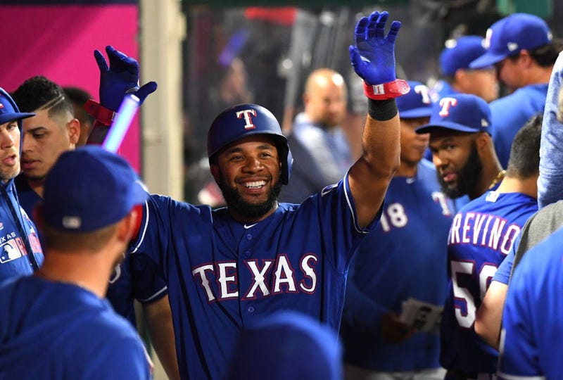 Elvis Andrus #1 of the Texas Rangers is greeted in the dugout after scoring a run in the sixth inning against the Los Angeles Angels at Angel Stadium on August 28, 2019 in Anaheim, California.