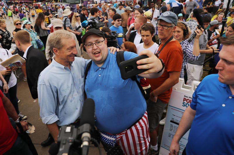 Democratic presidential candidate Tom Steyer (L), a billionaire hedge fund manager and activist, poses for a selfie at the Iowa State Fair August 11, 2019 in Des Moines, Iowa.