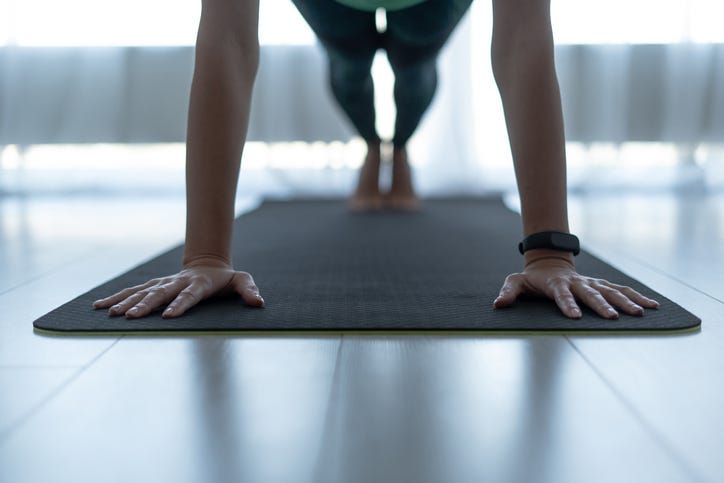Woman exercising on fitness mat