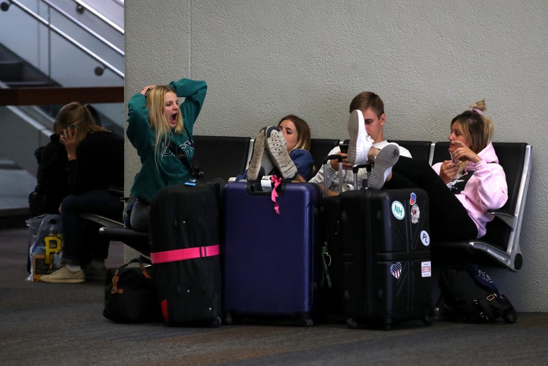 Travelers sit on a bench at San Francisco International Airport on September 09, 2019 in San Francisco, California.