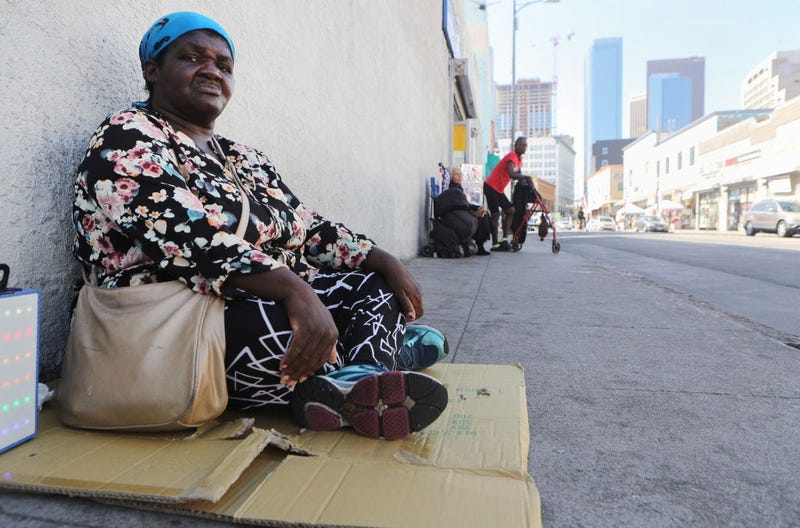 Margaret, who has been homeless since 2016, sits on the sidewalk in Skid Row on September 17, 2019 in Los Angeles, California.