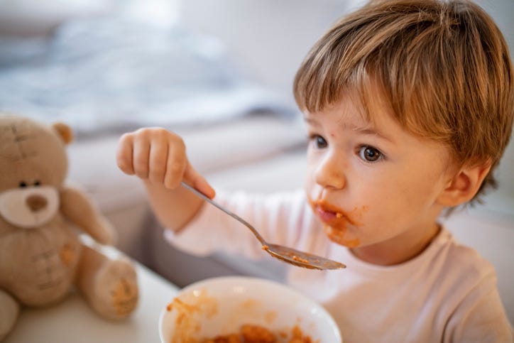 kid eating soup