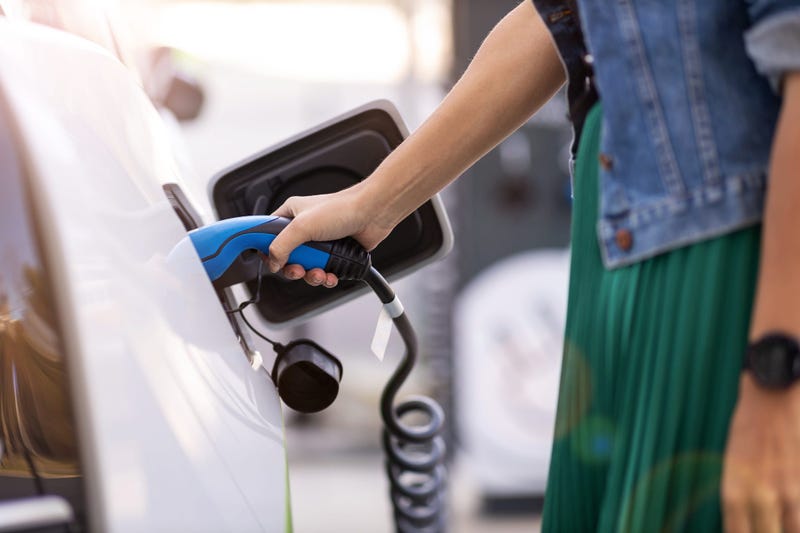 Woman charging an electric car