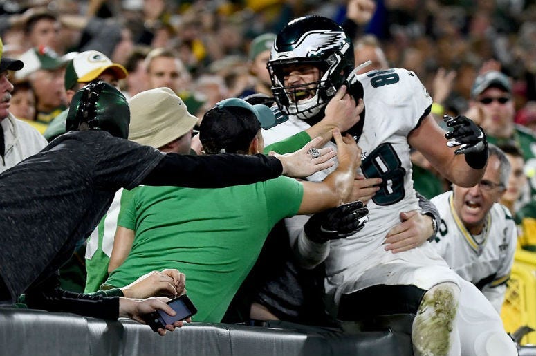 Dallas Goedert #88 of the Philadelphia Eagles celebrates his touchdown with fans in the second quarter over the Green Bay Packers during the game at Lambeau Field.