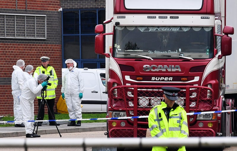 Police and forensic officers investigate a lorry in which 39 bodies were discovered in the trailer, as they prepare move the vehicle from the site on October 23, 2019 in Thurrock, England.