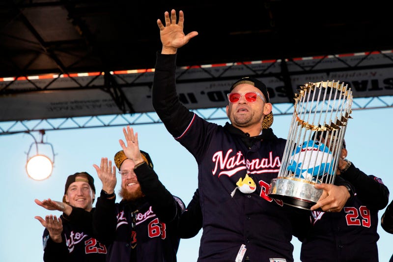 Gerardo Parra of the Washington Nationals holds the Commissioner's Trophy on stage during Nats World Series parade.