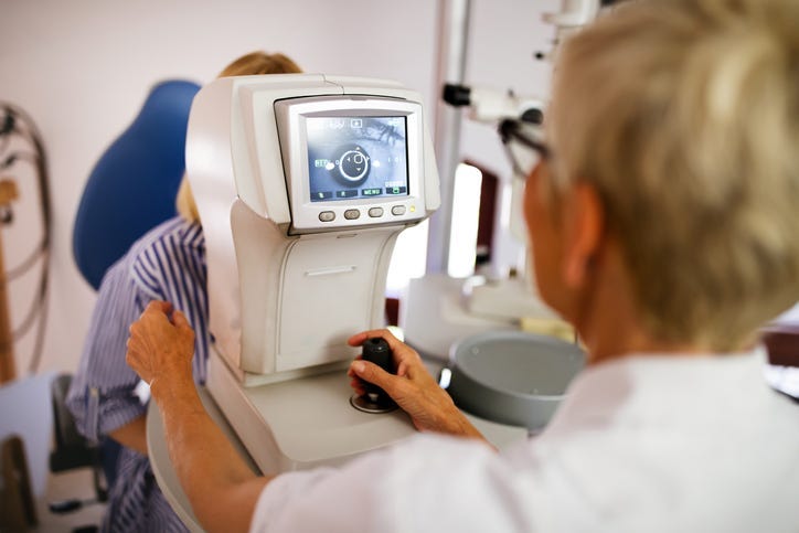 An eye doctor giving a test. 