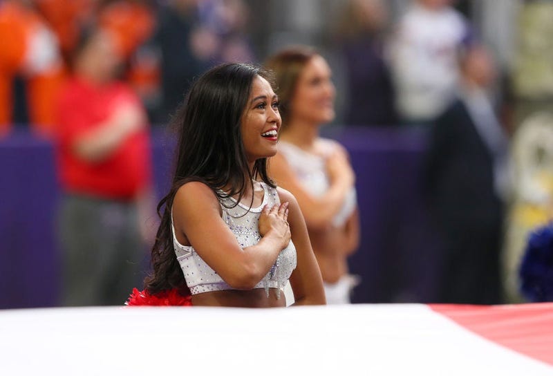 MINNEAPOLIS, MINNESOTA - NOVEMBER 17: A Minnesota Vikings cheerleader stands during the national anthem before a game between the Denver Broncos and the Minnesota Vikings at U.S. Bank Stadium on November 17, 2019 in Minneapolis, Minnesota. (Photo by Adam